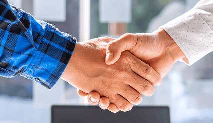 Handshake between two professionals in a business setting.