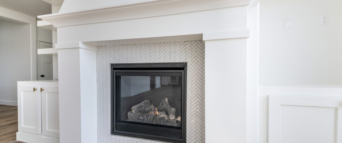 A fireplace with a white mantle in a modern room